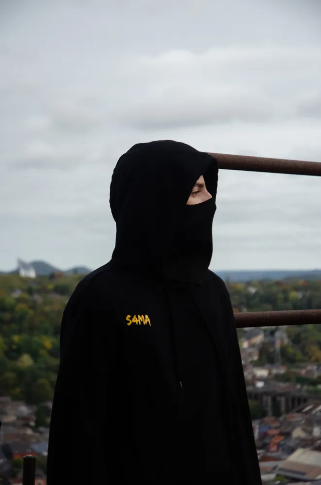 Silhouette encagoulée au-dessus de la ville